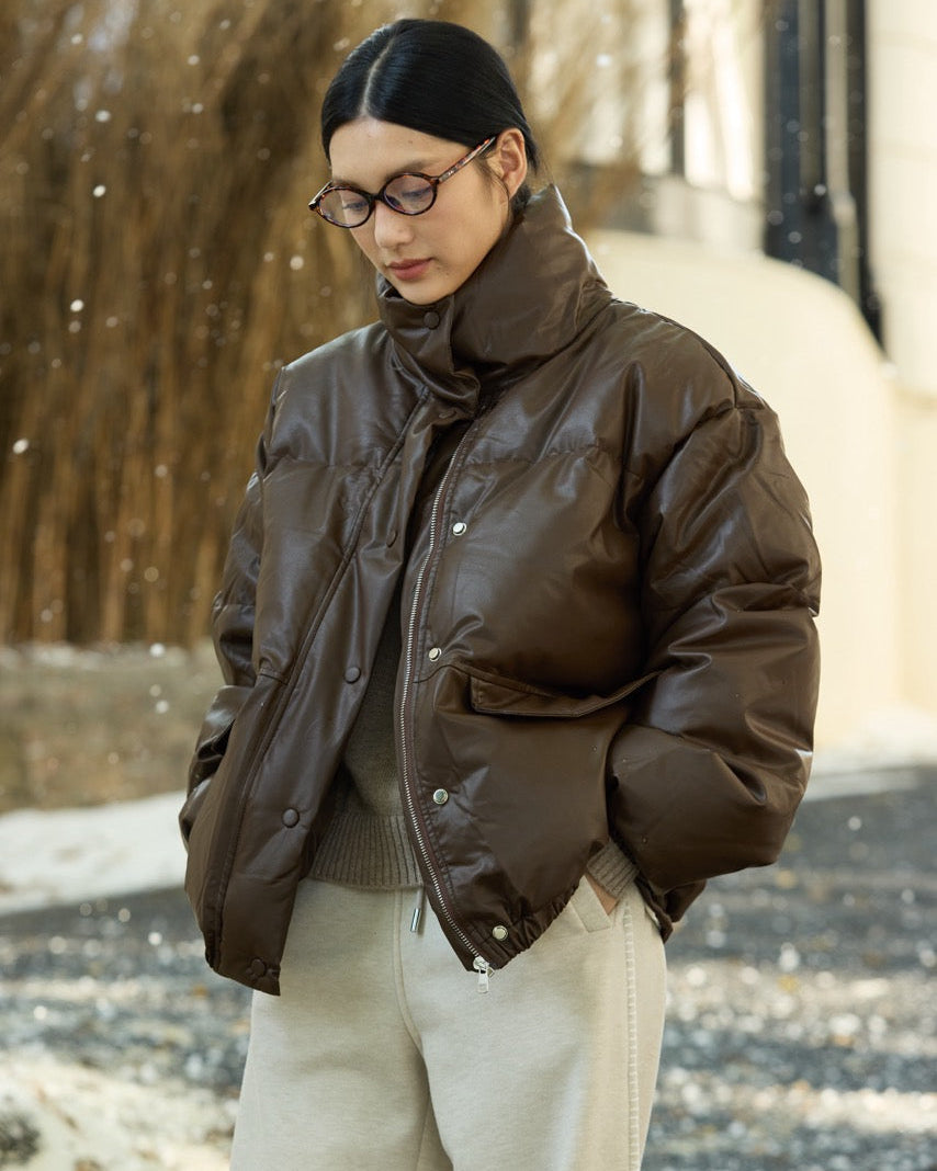 woman wearing a brown puffer jacket in a snowy outdoor setting