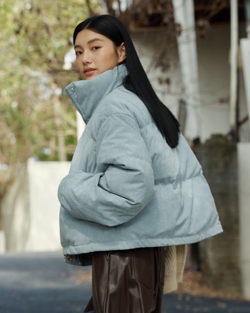 woman wearing a light blue puffer jacket outdoors