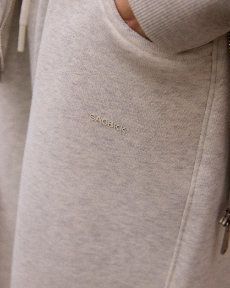 Close-up of a light gray hoodie with 'SAGBIK' branding on the chest.