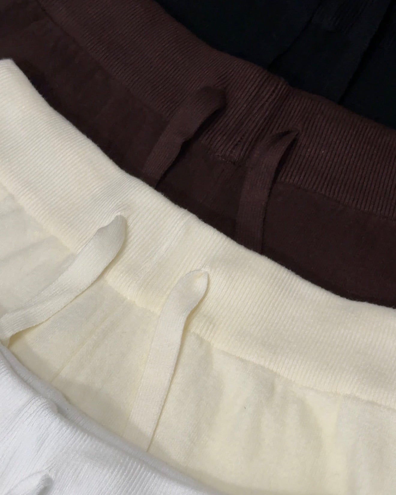 Close-up of brown, beige, and white fabric with a textured pattern.