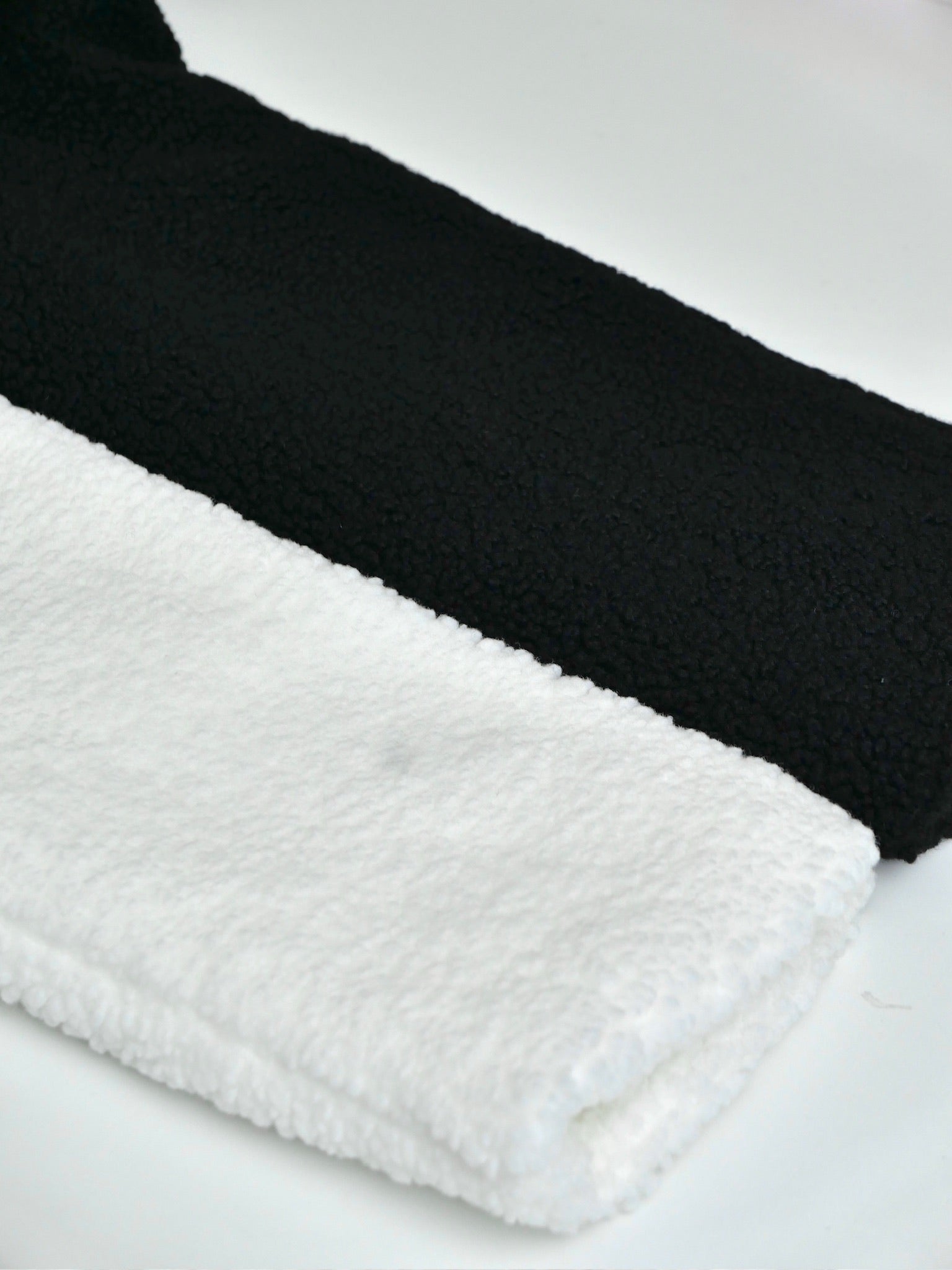 Black and white textured pillows on a light gray background