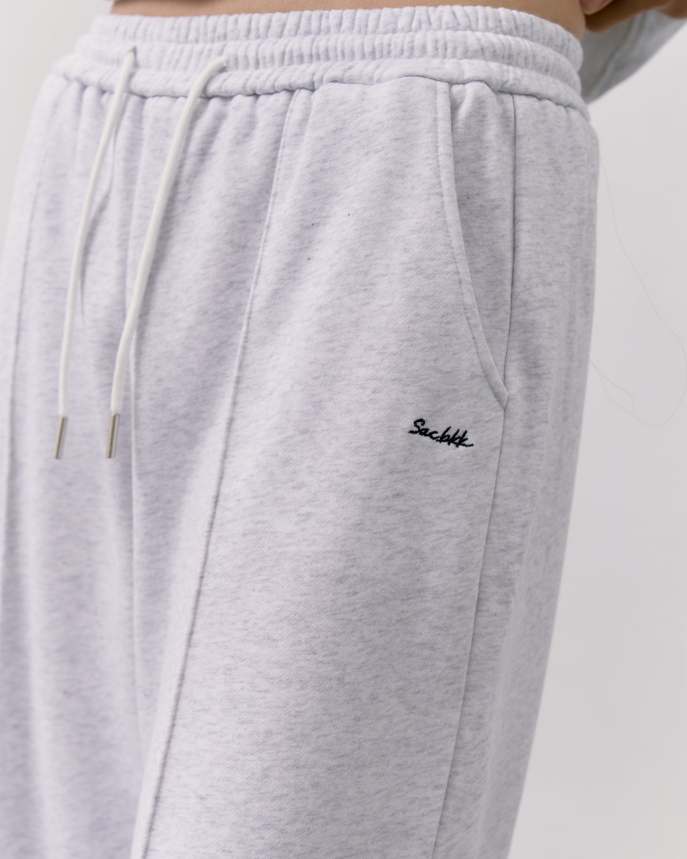 Gray sweatpants with a brand logo on a light gray background