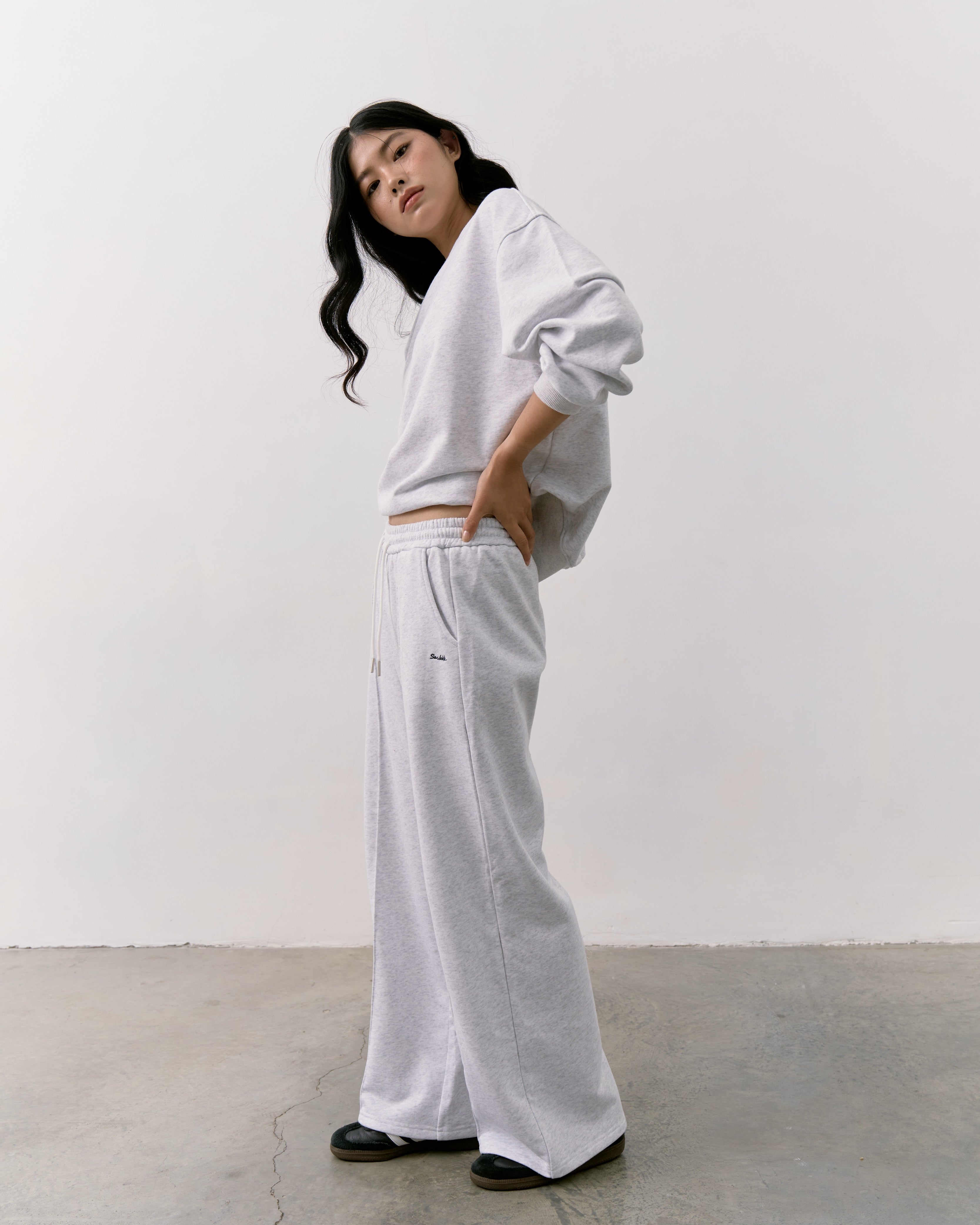 woman wearing a white outfit with a plain background